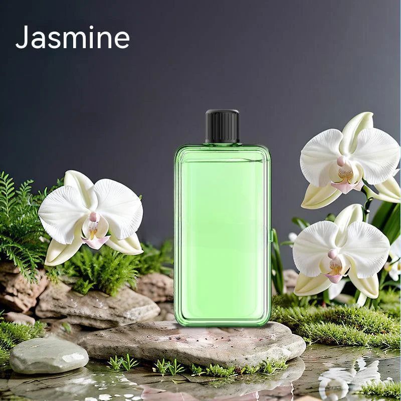 Green perfume bottle with white flowers on a natural background