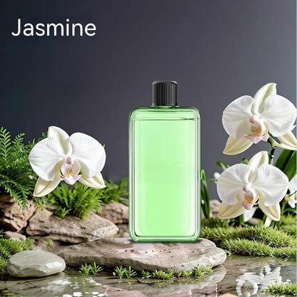 Green perfume bottle with white flowers on a natural background
